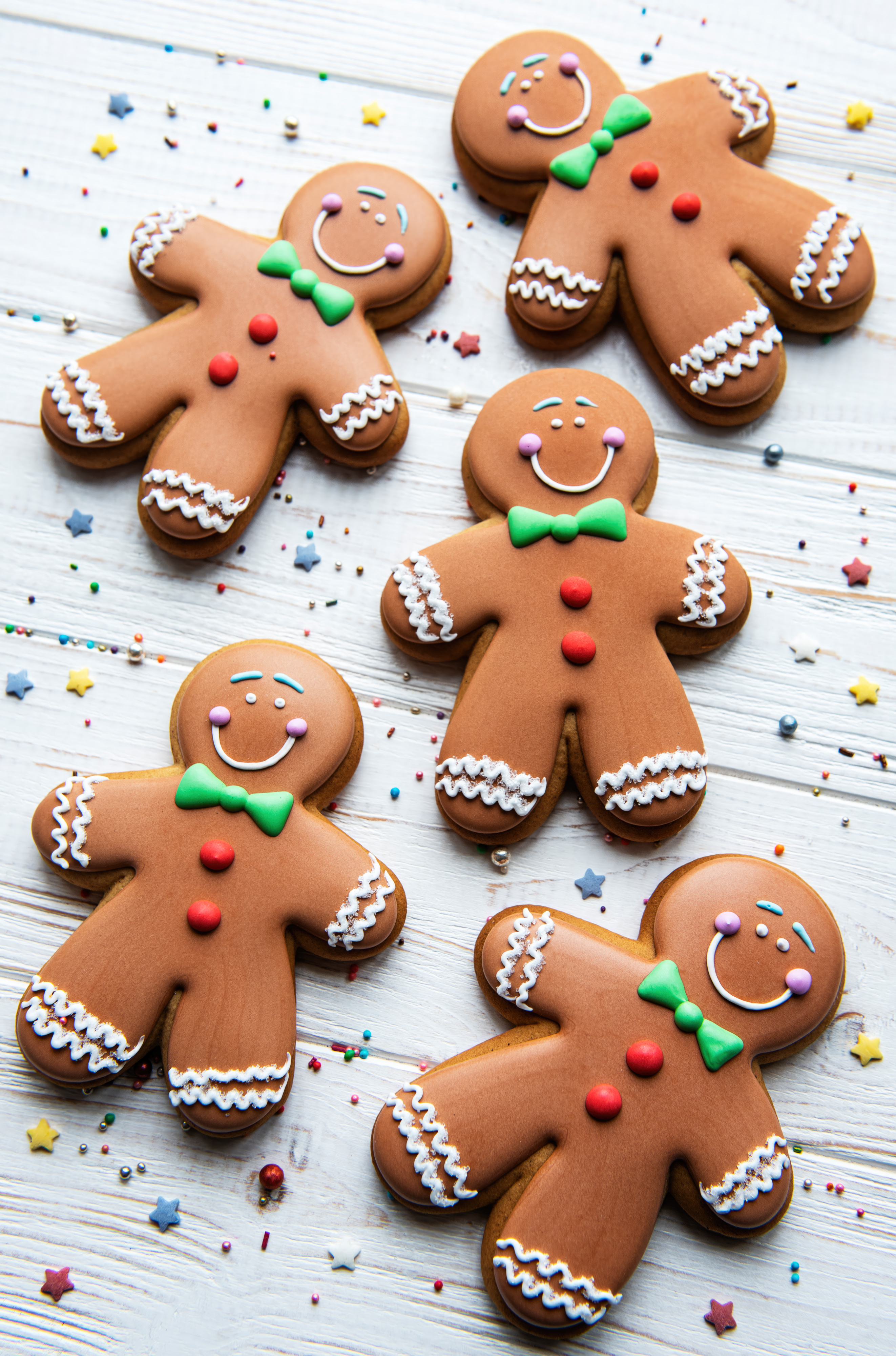 Homemade Christmas gingerbread men cookies on a white wooden background
