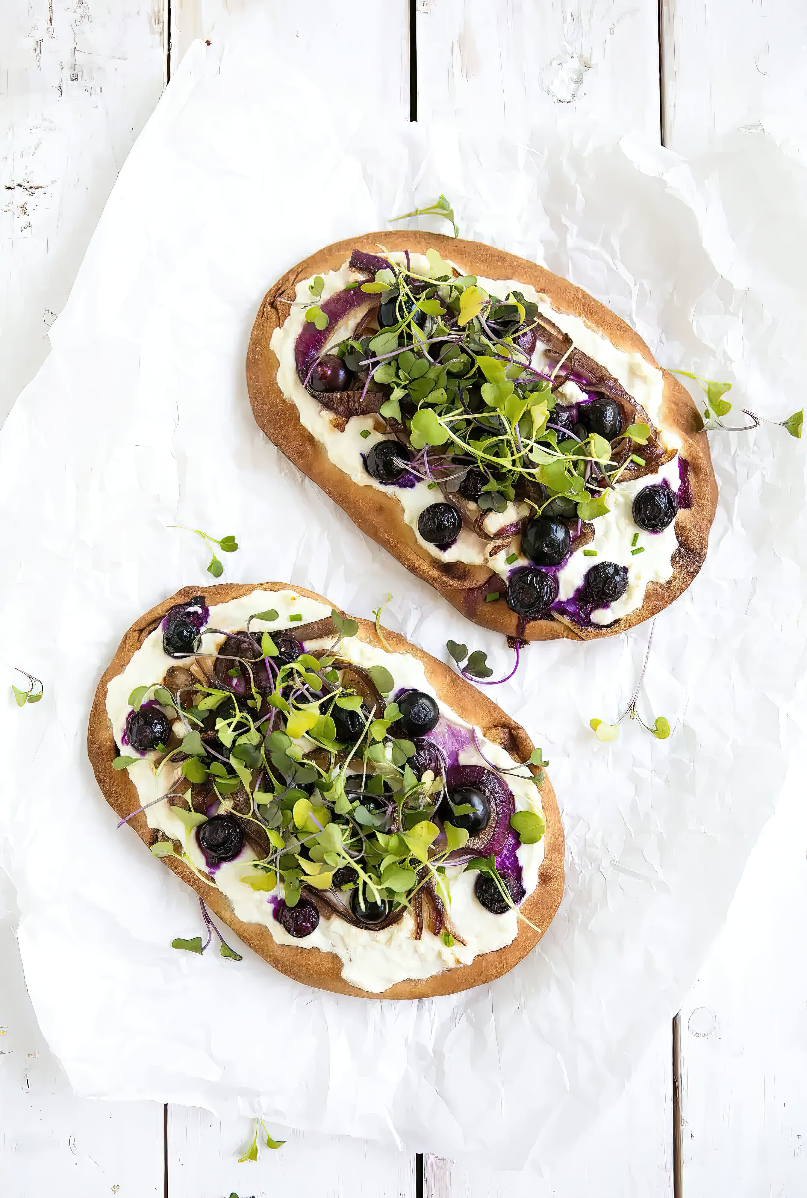 Close-up of blueberry and honey caramelized onion naan pizza