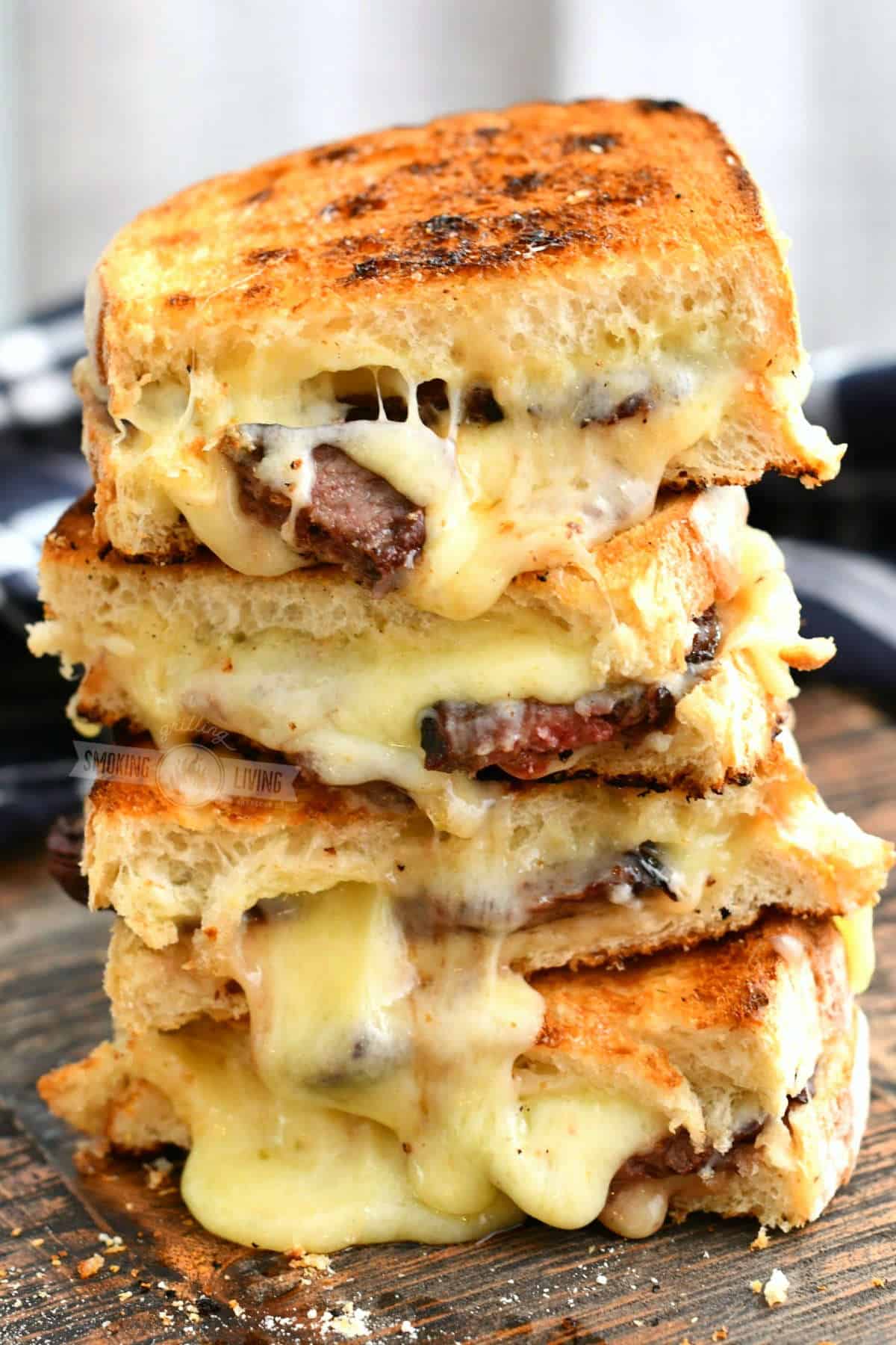 Stack of grilled cheese sandwiches on a cutting board