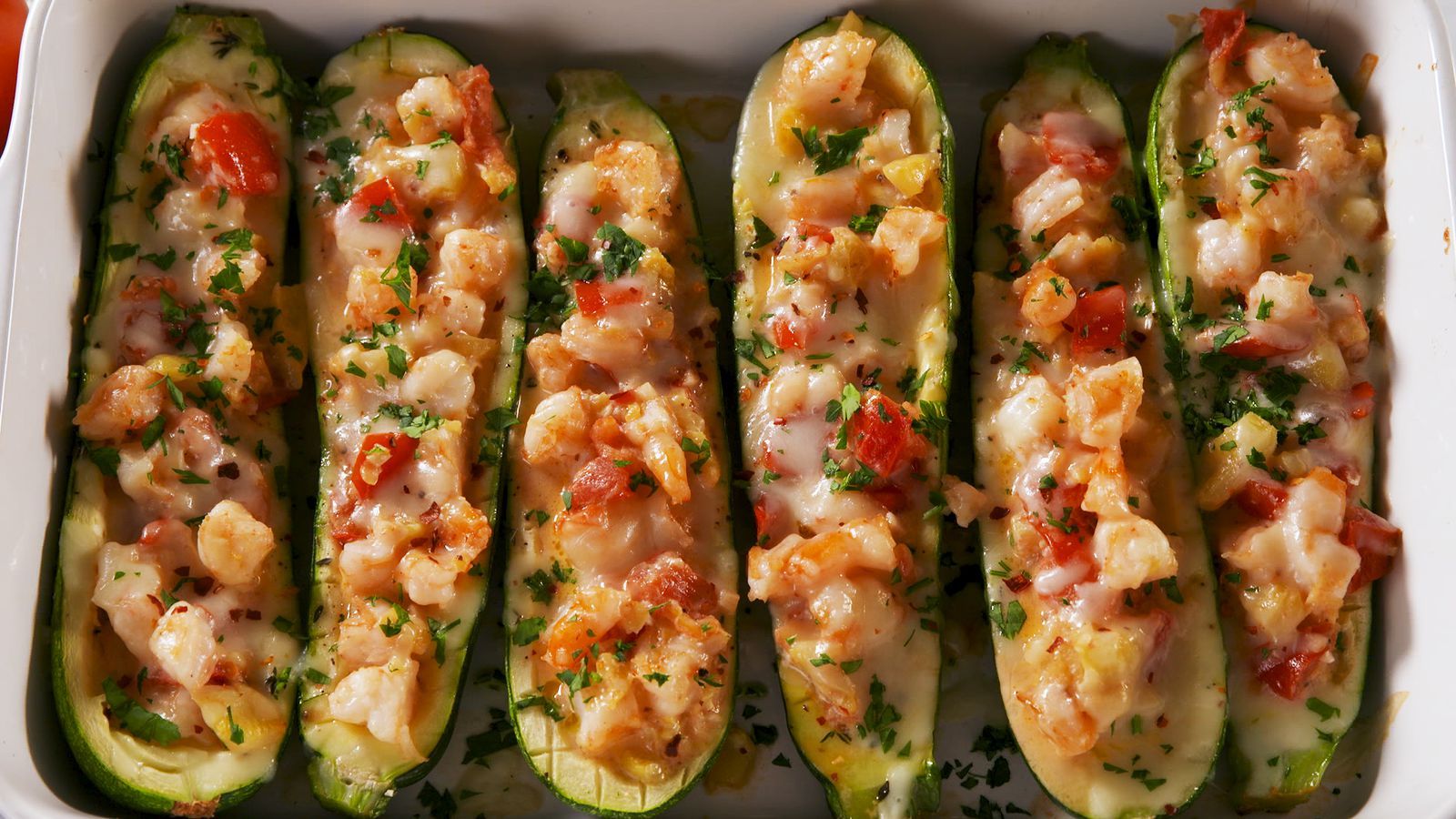 Close-up of garlicky shrimp zucchini boats on a table