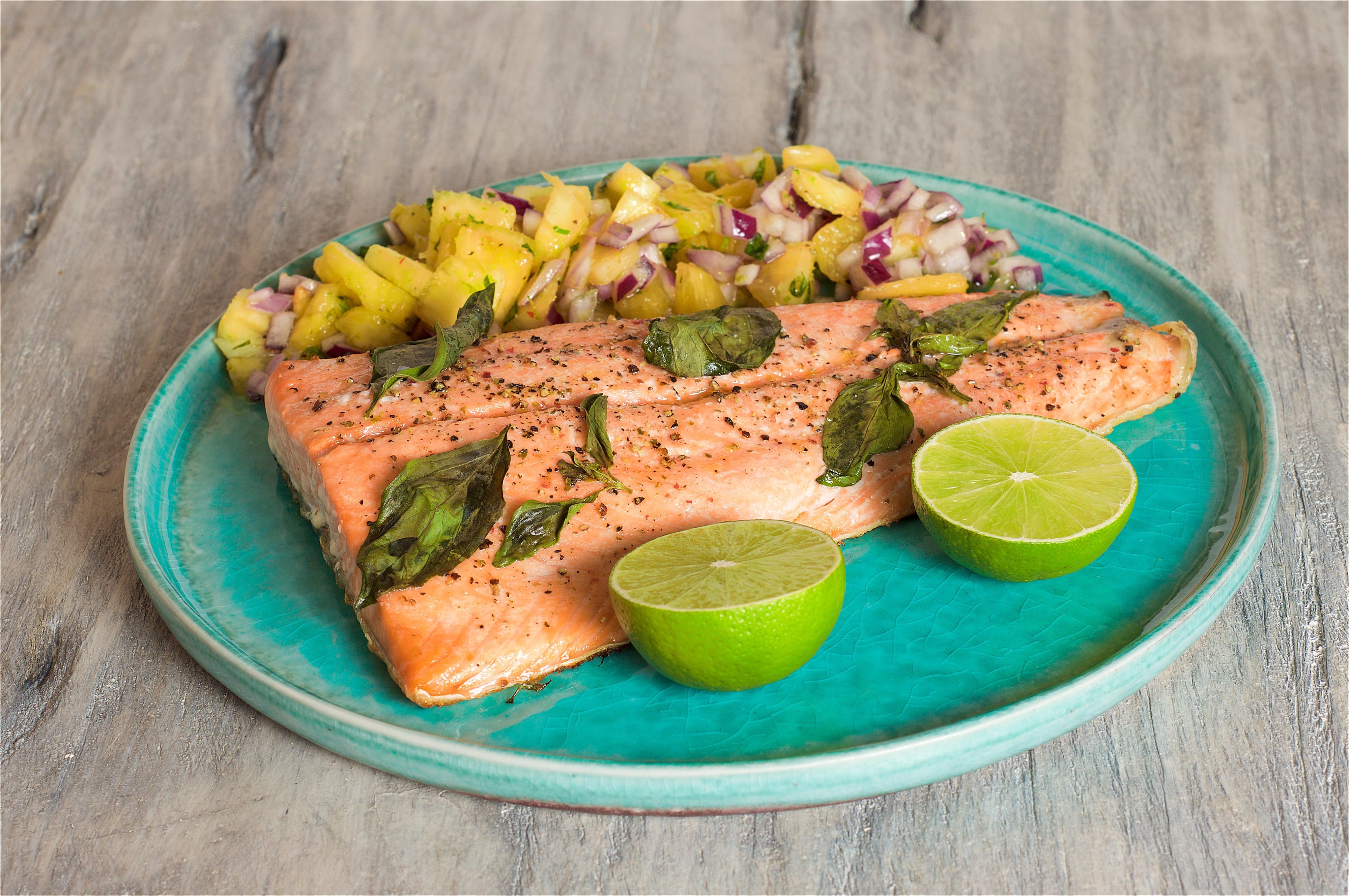 Close-up of grilled salmon with pineapple salsa on a plate