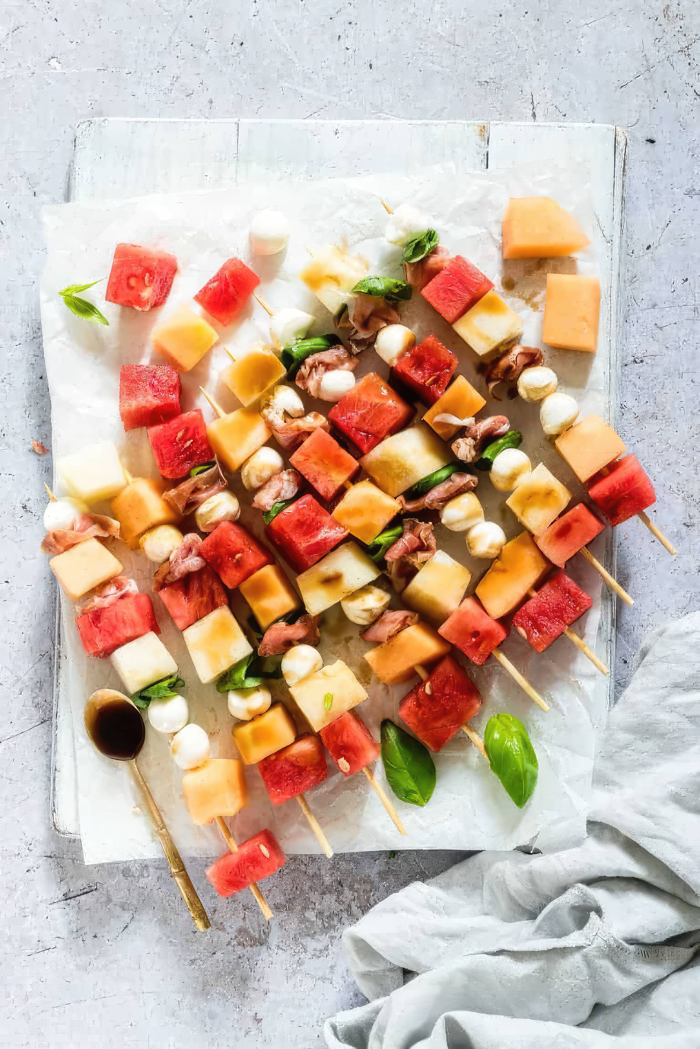 Watermelon and cheese skewers arranged on a pristine white paper