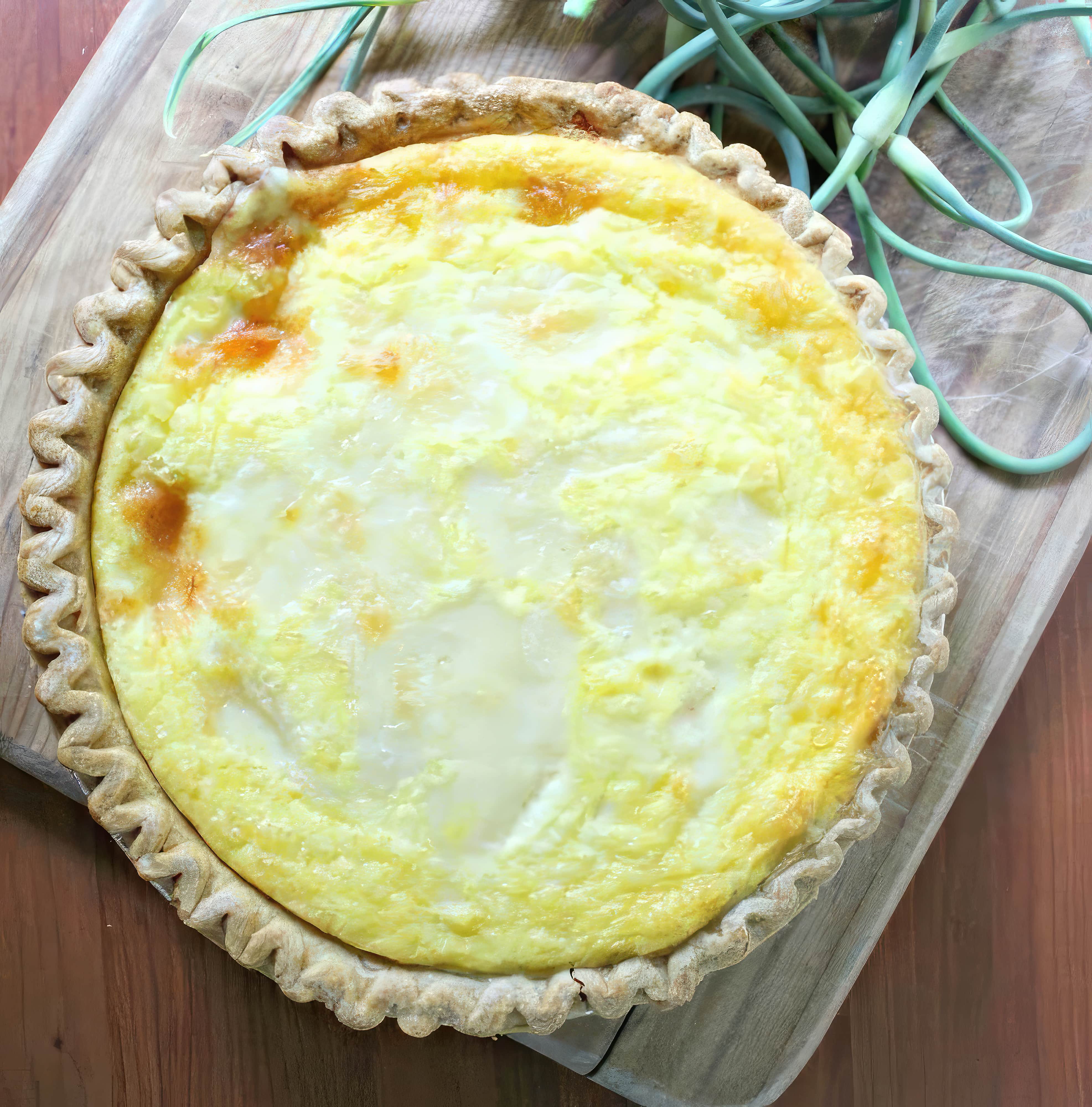 Close-up of summer quiche recipe with scapes and ham